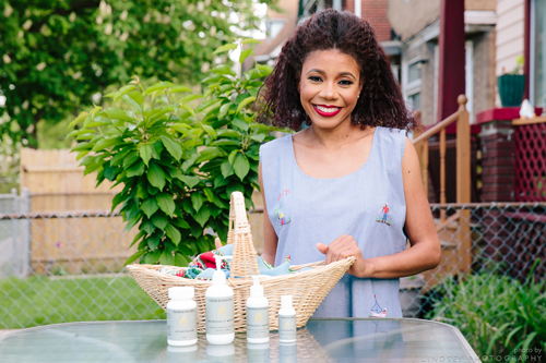 Carline Dugue standing near row of products